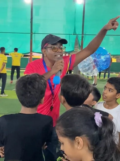 A coach rallies the troops with a microphone, getting everyone excited for the next activity. Our parties are high-energy, organized, and led by enthusiastic professionals.