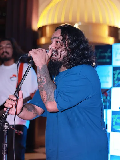 A side profile of our frontman, singing his heart out. You can see the passion and dedication in this shot.