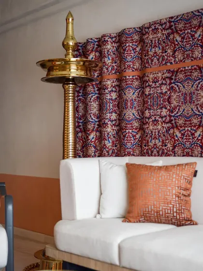 The stunning "Kalamkari fabric art piece" is the focal point of the living room. We chose light-colored furniture to allow the strong visuals of the fabric to stand out.