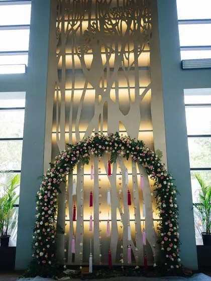 A wide shot showing how the tall space of the badminton court was utilized, with a large, elegant backdrop for the Mehendi ceremony.