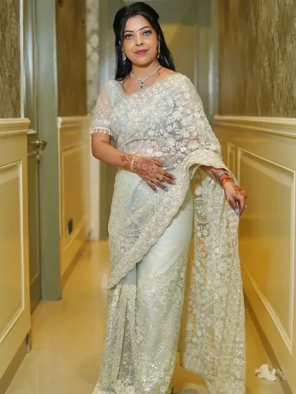 An elegant party guest in a white embroidered saree. I created a classic look with soft makeup and loose hair.