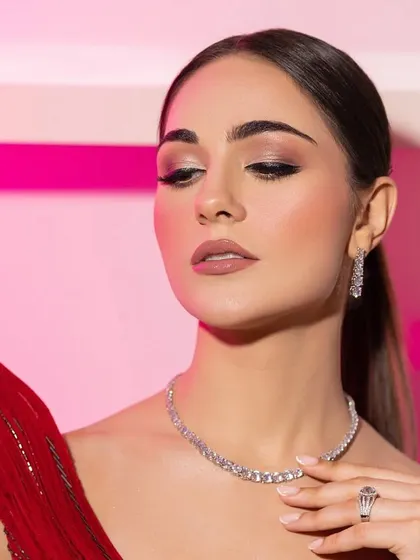 The model's serene expression and the delicate diamond necklace are the focus of this shot.