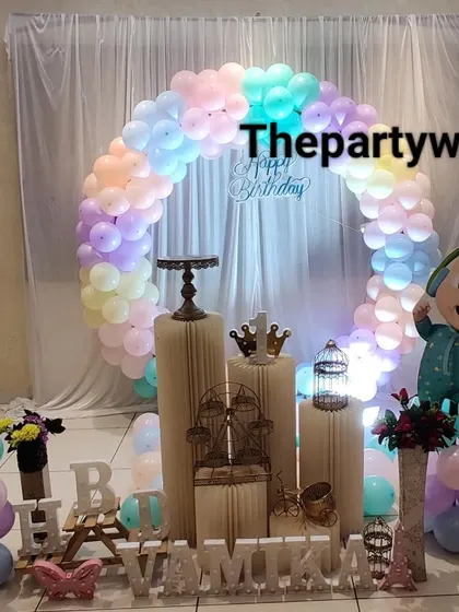A Cocomelon theme with a pastel balloon ring, creating a soft and sweet look for a birthday party.