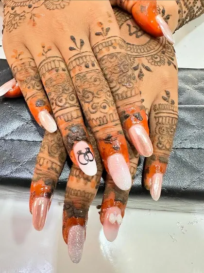 Here is the engagement nail art shown with the client's beautiful mehndi. The pearly finish of the nails provides a lovely contrast to the rich color of the henna.