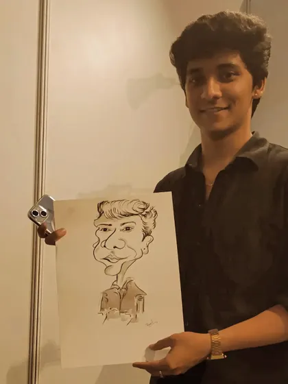 A guest from a Redbull gaming event, holding his caricature.