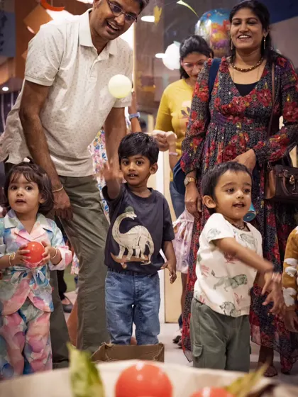 The pure joy of a child at play during a Dino Carnival event I organized. I capture these unscripted moments of fun that families will cherish for years to come.