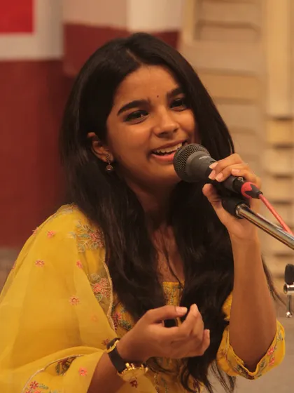 The joy of performance shining on a young student's face.