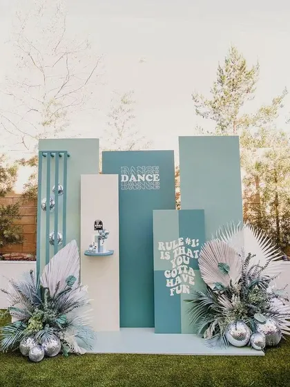 This custom-designed backdrop is perfect for an adult birthday or bachelorette party. The cool color palette and fun quotes create a stylish and relaxed vibe for an outdoor celebration.