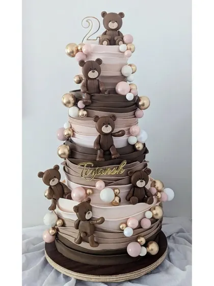 We went all out for this teddy bear-themed second birthday cake. The cascading fondant ribbons and adorable bears create a grand and playful look.