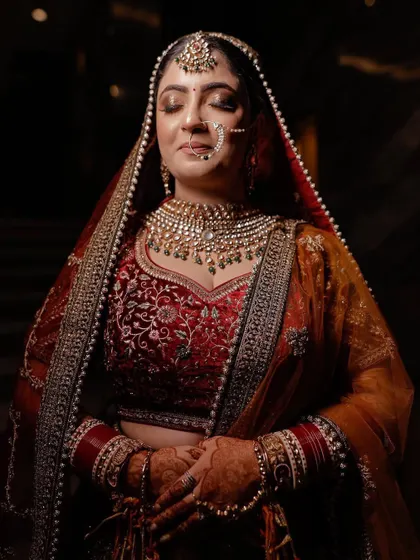 Our bride Charu looking royal in a multi-toned lehenga and a heavy polki and pearl bridal set.