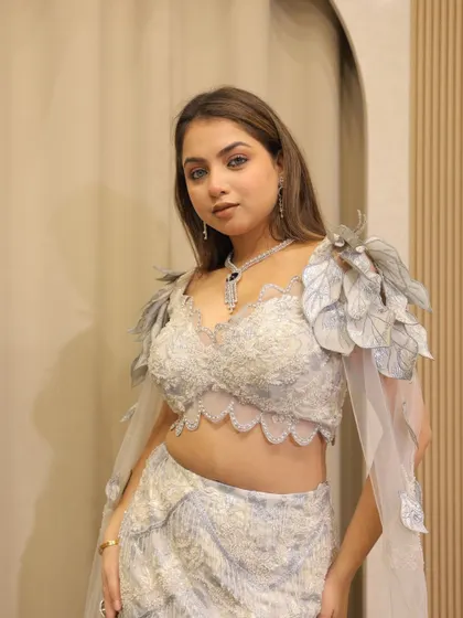 Keeping up with the trends with this fish-cut lehenga featuring unique leaf-like shoulder details. A perfect blend of nature-inspired design and modern glamour.