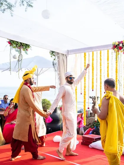 The groom and his friends dancing during the wedding rituals, showing the fun and festive atmosphere of the celebration.