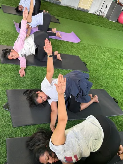 More from our International Yoga Day celebration, with members holding a synchronized twisting pose.