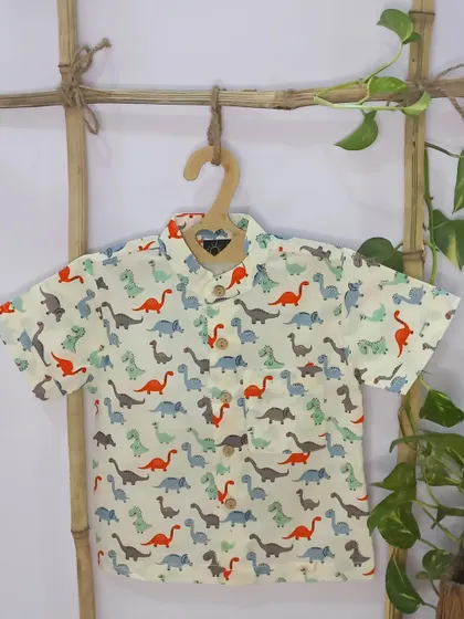Another version of our popular dino print shirt, this one with pops of red and blue. The quirky print and comfortable fit make it a go-to choice for summer.