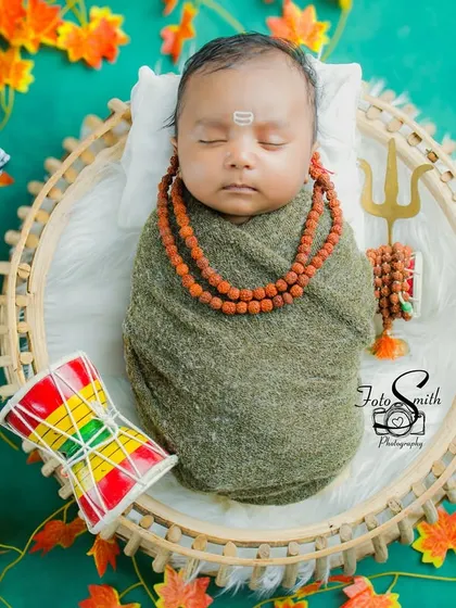 This close-up shot of the sleeping baby Shiv is incredibly peaceful. The focus is on his serene expression and the traditional elements that make this theme so special.