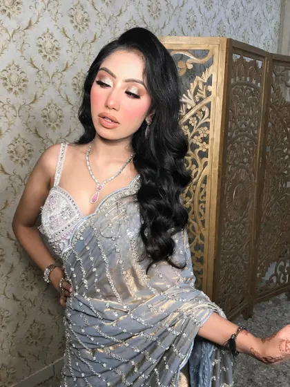 The full look, showing the elegant drape of the saree and the Hollywood waves.