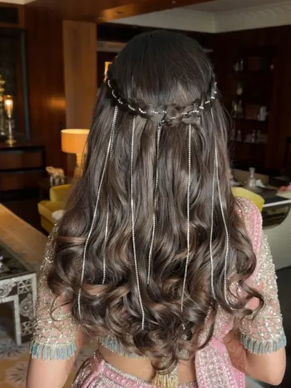 A detailed shot of the half-up style with sparkling stone strings, showing how they cascade through the soft waves.