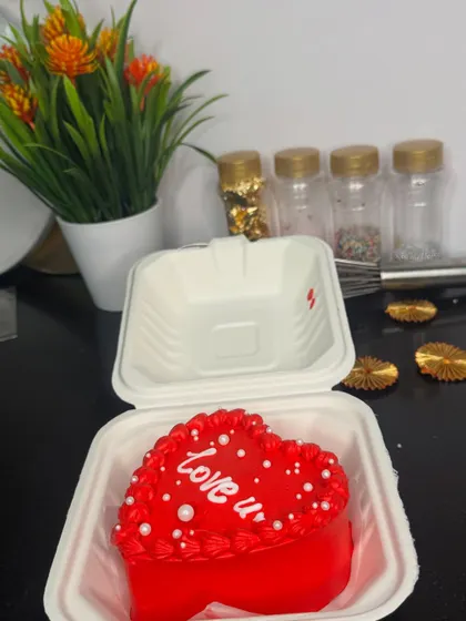 A bright red, heart-shaped bento cake with a simple "love u" message. Packed in its cute little box, it's a perfect surprise gift full of sweetness and smiles.
