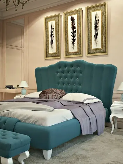 A bedroom featuring a bold, teal-colored, button-tufted wingback bed, showcasing our custom furniture design capabilities.