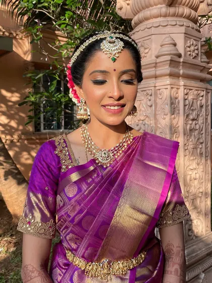 A close-up of the bride's soft glam makeup. The subtle shimmer on the eyes and the perfectly blended base create a look that is both traditional and fresh.