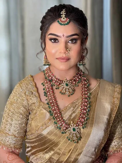 A direct portrait showing the symmetry and precision of the makeup application, from the perfectly defined brows to the balanced contour.