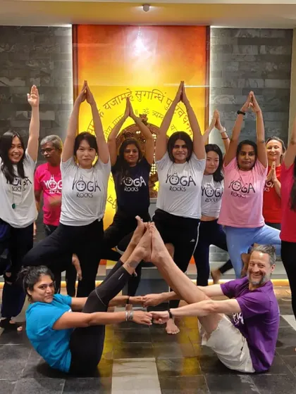 A fun and creative group Acro Yoga pose. We love finding new ways to connect and build together as a community.