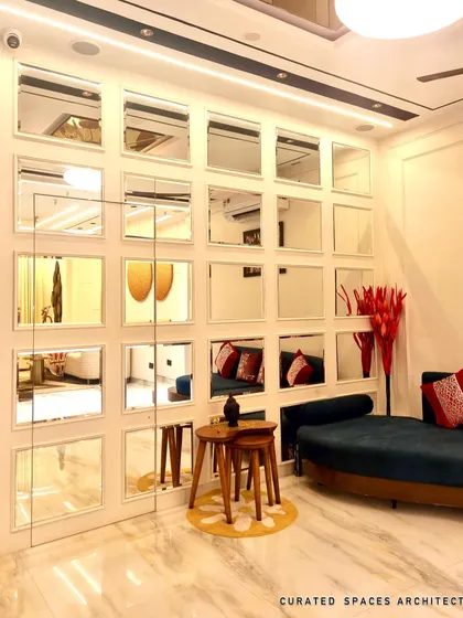 A closer look at the grid-style mirror wall I designed. This feature not only adds a decorative element but also makes the entire living area feel larger and brighter by reflecting light and space.