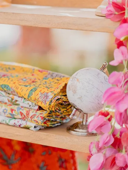 A small detail from our 'Rajasthani Folklore' Mehendi. We used a miniature globe and stacks of colorful, block-printed fabrics to create charming little vignettes.