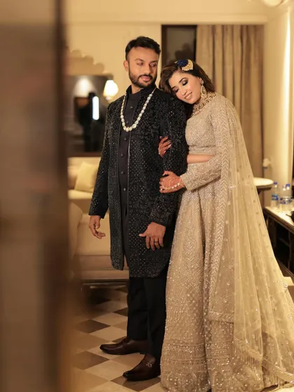 A candid shot of the couple at their Sangeet. The bride's makeup is glamorous and elegant, perfect for the occasion.
