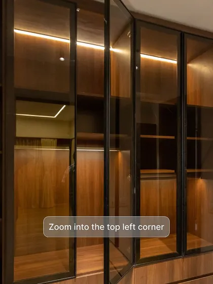 I love creating smart storage solutions. This wardrobe with glass doors has a secret: extra concealed storage at the top for items you don't use every day. It's all about maximizing every inch of space.