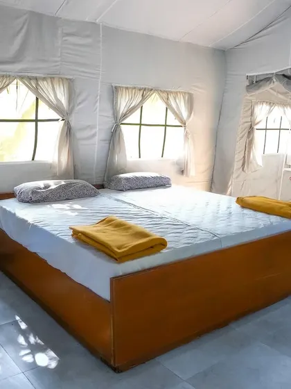 Inside our Swiss cottages, you'll find clean and comfortable bedding. We ensure these spaces are well-maintained to provide a restful night's sleep during your overnight outing.