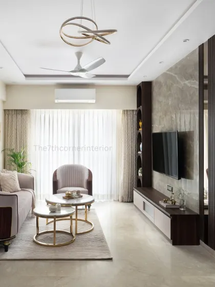 A complete view of the living area, showcasing the Italian marble TV wall, curved display niches, and the sleek, handle-less media unit. The design ensures that function and luxury are seamlessly integrated.