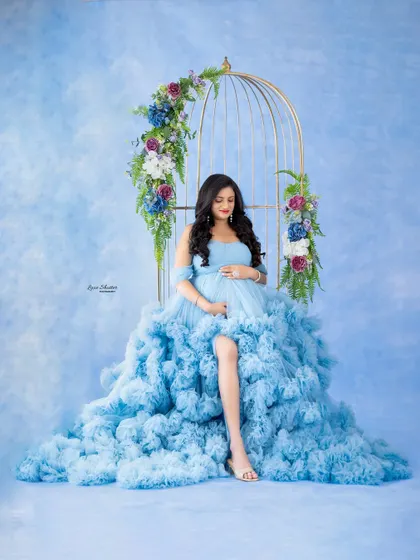 This seated pose allows the voluminous ruffles of the gown to cascade beautifully, creating a cloud-like effect that is pure magic.