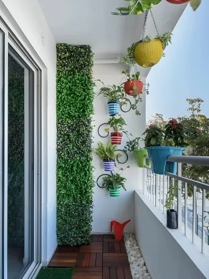 This design shows how to add personality to a simple balcony. A narrow vertical garden and quirky bicycle-shaped wall planters bring life and character to the space without taking up valuable floor area.
