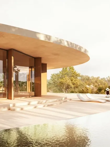 The elegant curve of the roof provides shade for the outdoor terrace, creating a comfortable space to enjoy the views.