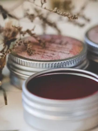A close-up of the deep red lip and cheek tint. This product gives you a buildable color, so you can go for a sheer wash or a more intense look.