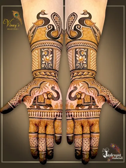 A bold and beautiful symmetrical design featuring pairs of elephants on the palms and elegant peacocks on the forearms. The use of negative space makes the motifs pop.