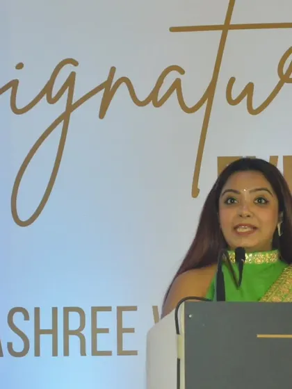 At the podium during the Dhanashree Wealth Signature Event 2024. The branding and stage setup were designed to reflect the professional and forward-looking nature of the asset management firm.