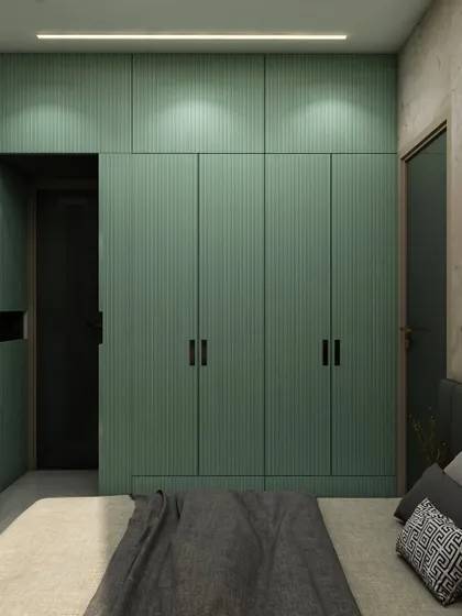 A closer look at the mint green fluted wardrobes, which add a subtle texture and a pop of color to the serene bedroom design.