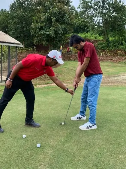 Our coach giving Jitendra Kumar a hands-on lesson in putting alignment. Even a small adjustment can make a big difference in sinking the ball.