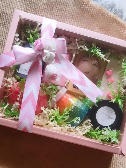 This bridesmaid gift hamper is designed to pamper. It includes a custom name soap, body wash, body lotion, bath salts, and other treats, all elegantly arranged in a pink gift box.