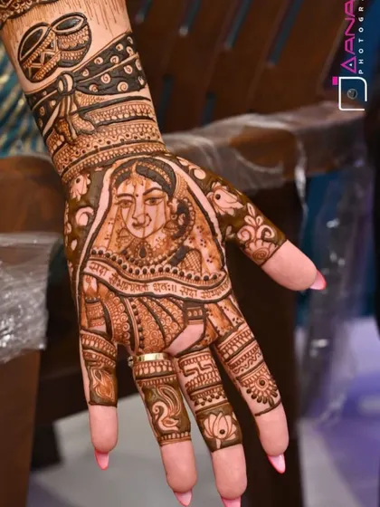 A detailed portrait of the bride on her palm, with the "Sada Saubhagyavati Bhava" blessing. The design is framed by swans and lotus flowers.