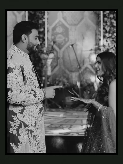 A candid black and white shot of the couple sharing a laugh. This photo perfectly captures their playful interaction and genuine happiness, showcasing the unscripted moments we cherish.