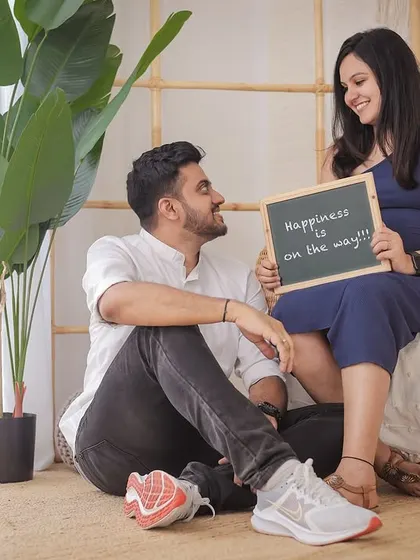 A relaxed and happy couple's shot. Using a simple chalkboard prop is a great way to share your message and add a personal touch to your pregnancy photos.