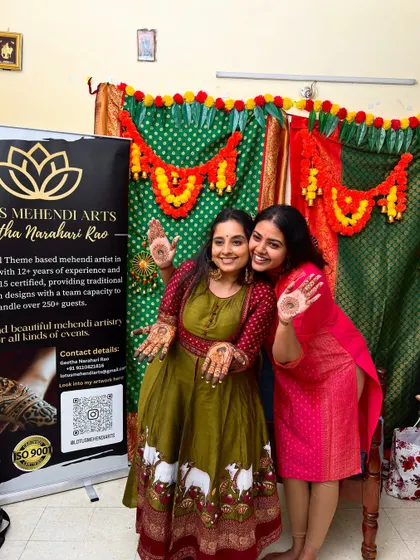 A photo of me with the lovely actress Chandana, both of us with happy, henna-adorned hands.