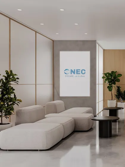The waiting lounge of the eye clinic embraces elegance with subtle warmth. Soft, modular seating, warm wood paneling, and lush indoor plants create a comfortable and relaxing environment for visitors.