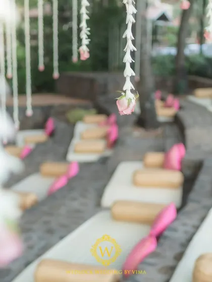 A mix of traditional floor seating and elegant Tiffany chairs for a wedding ceremony. This arrangement respects the venue's unique amphitheater layout while ensuring guest comfort.
