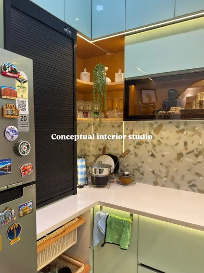 A close-up on the practical details. This kitchen includes a dedicated appliance garage with a roller shutter and open wicker baskets for easy-to-access vegetable storage.