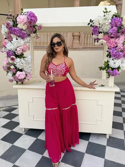 A pretty pink affair for a daytime Mehendi. This sharara set with mirror work is festive, fun, and perfect for a celebration.