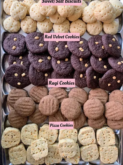 A tray of assorted homemade cookies: Sweet/Salt Biscuits, Red Velvet, Ragi, and Pizza Cookies.